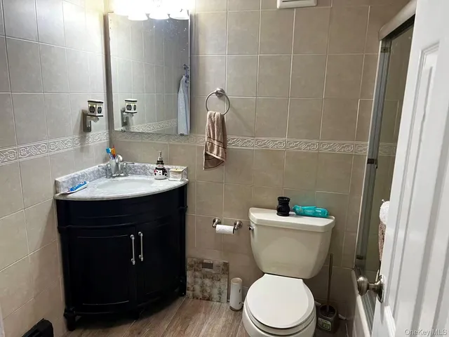 a bathroom with a sink toilet and a mirror