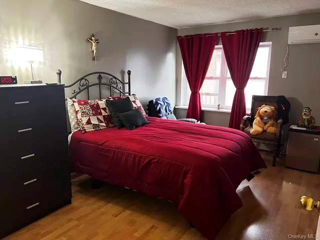 a bed sitting in a bedroom next to a window