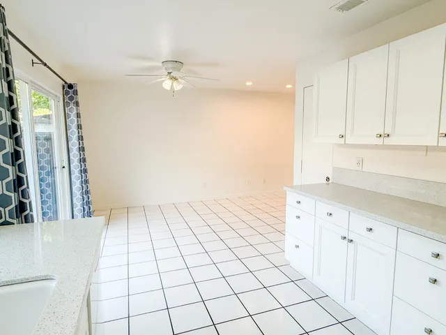 a view of a kitchen with white cabinets