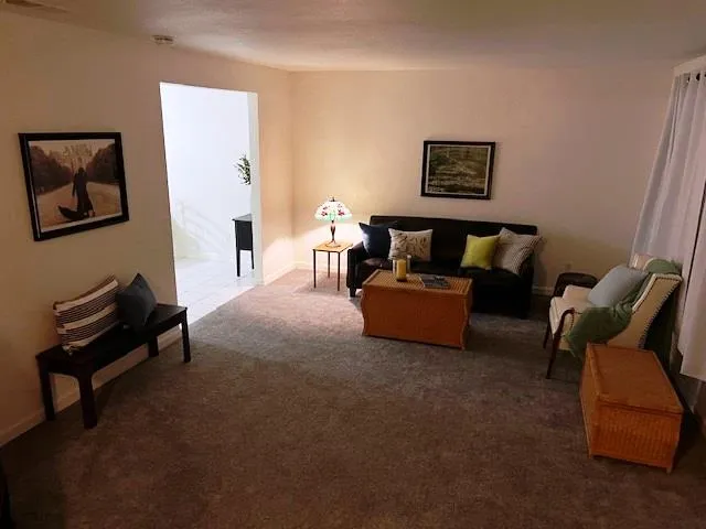 a living room with furniture and a piano