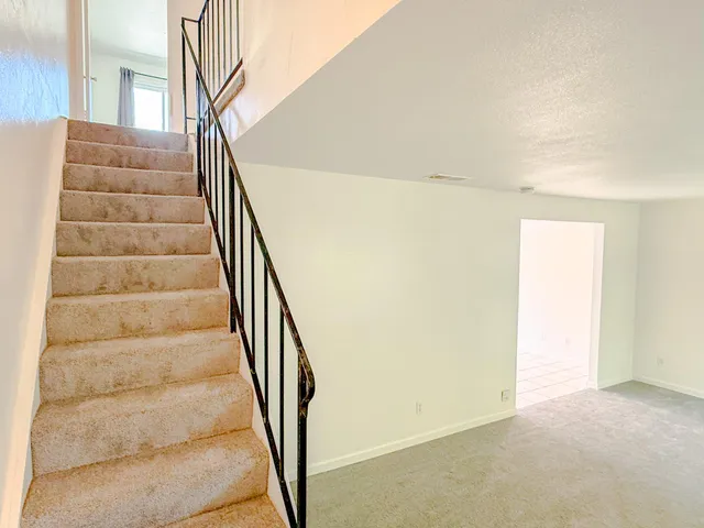 a view of staircase with white walls