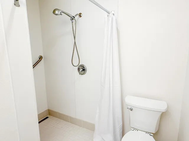 a view of a backyard with table and chairs potted plants