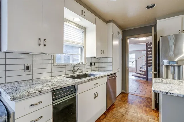 a kitchen with a sink stove and cabinets