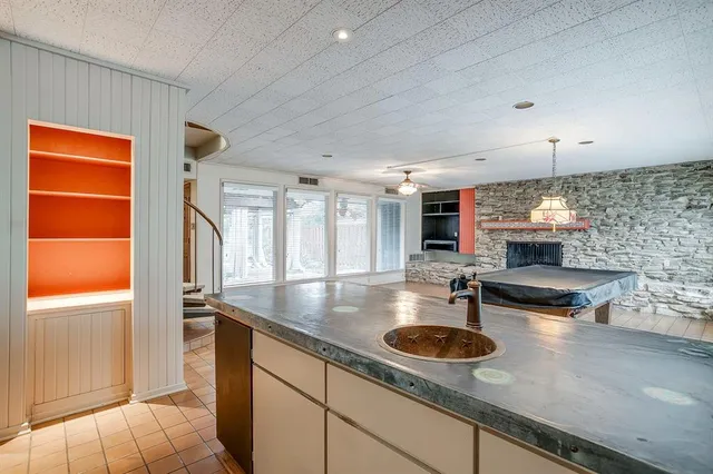 a kitchen with a sink appliances and a counter top space
