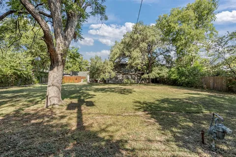 a view of a yard with trees