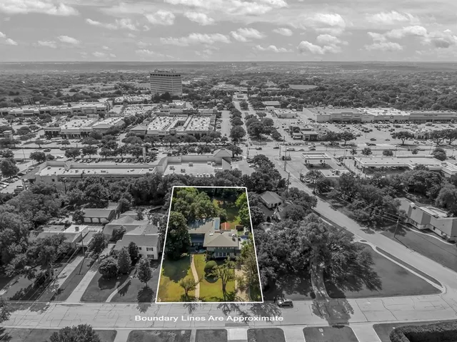 an aerial view of residential houses with yard
