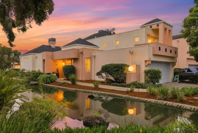 a front view of a house with swimming pool and a yard