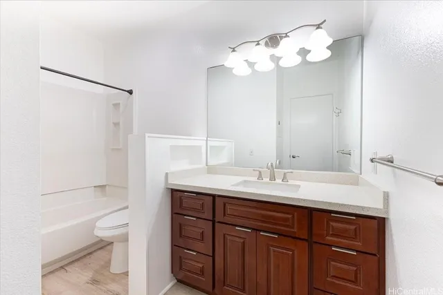 a bathroom with a sink a toilet and a mirror