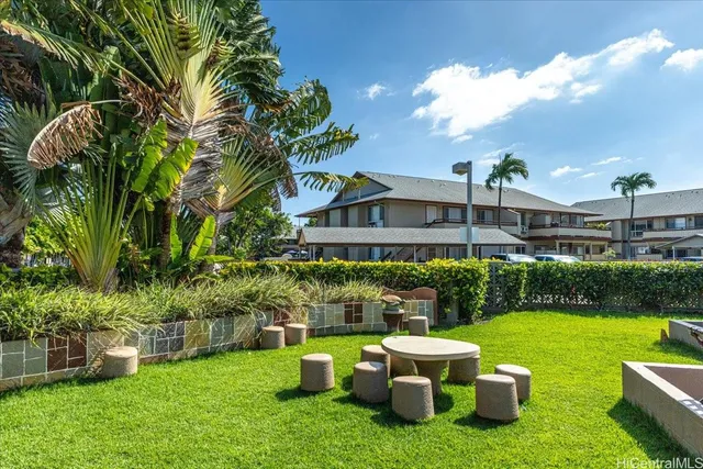 a view of a house with backyard sitting area and garden