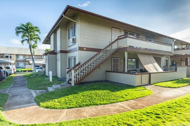a front view of a house with a yard table and chair