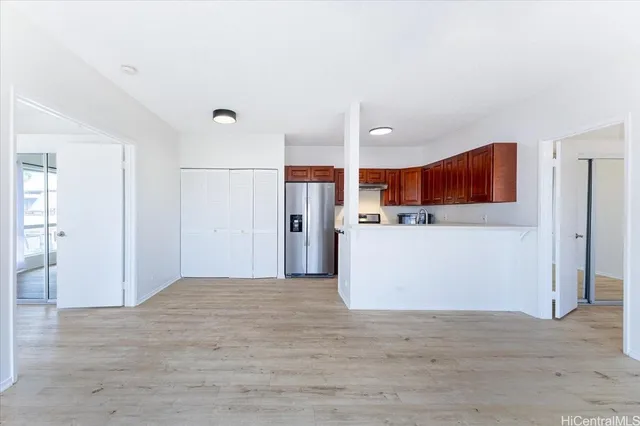 a view of kitchen with cabinets and refrigerator