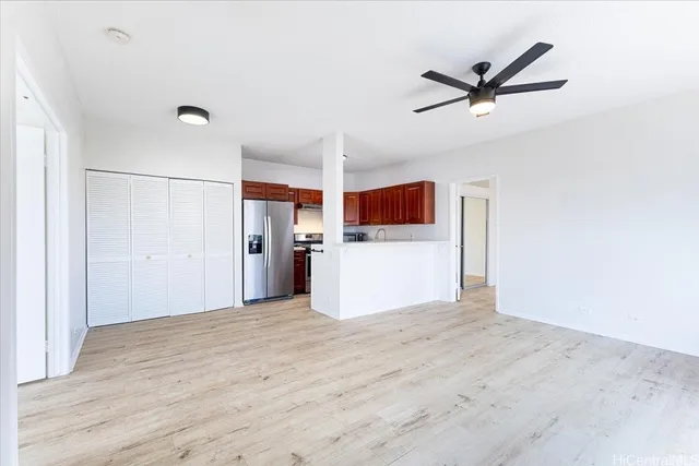a view of a kitchen with a sink and wooden floor