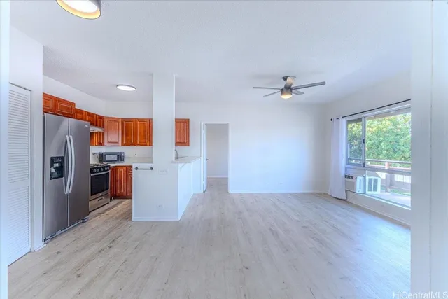 a view of a kitchen with a sink a refrigerator and wooden floor