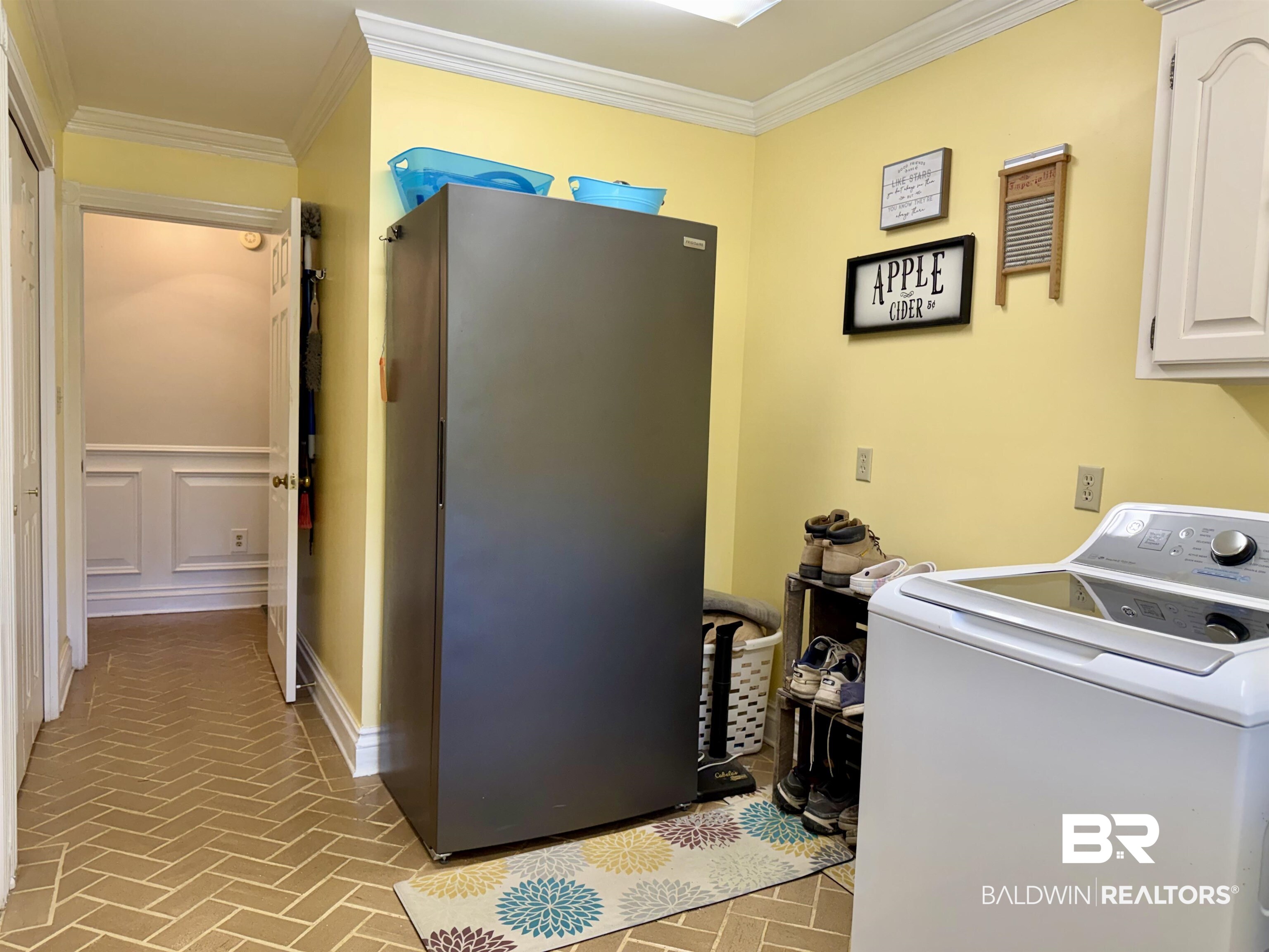 2944 Appleton Road Brewton, AL 36426 - Photo 32 of 65 Laundry area featuring washer / dryer, brick patterned floors, crown molding, and cabinet space