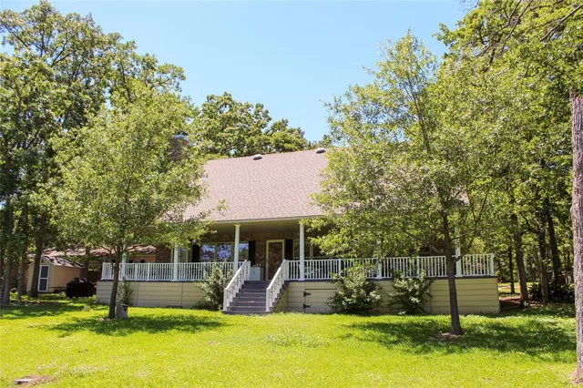 a view of a patio with a table and chairs under an umbrella