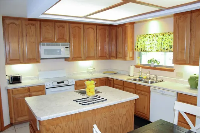 a kitchen with stainless steel appliances a stove a sink dishwasher and a microwave