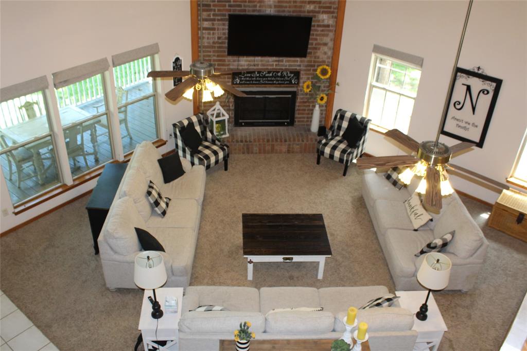 6928 Scott Street Eustace, TX 75124 - Photo 16 of 37 a living room with furniture a flat screen tv and a fireplace