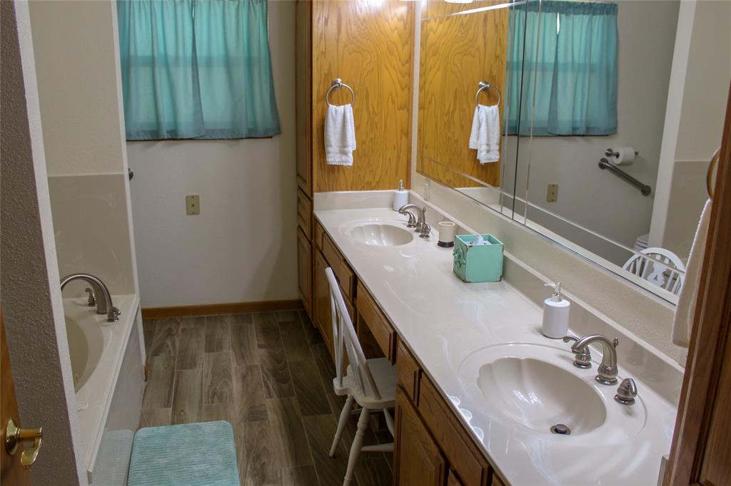 6928 Scott Street Eustace, TX 75124 - Photo 18 of 37 a bathroom with a sink and a mirror