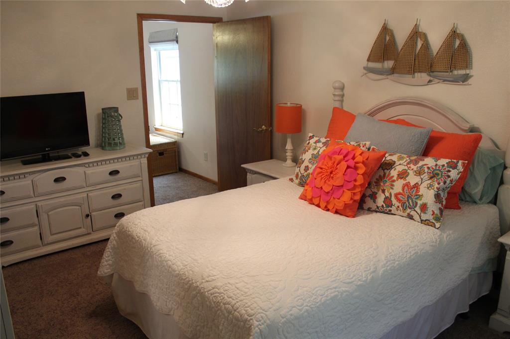 6928 Scott Street Eustace, TX 75124 - Photo 21 of 37 a bedroom with a bed and a flat screen tv