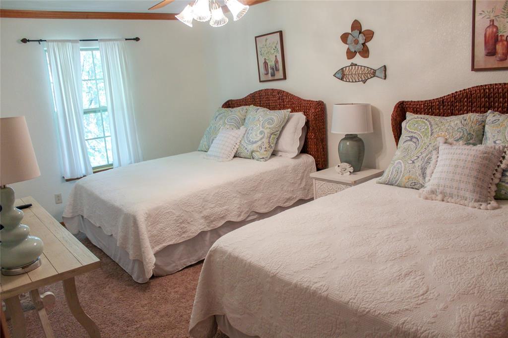 6928 Scott Street Eustace, TX 75124 - Photo 25 of 37 a bedroom with two beds and painting on the wall