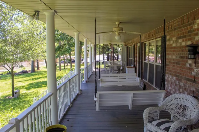 a view of a porch with wooden floor and outdoor space