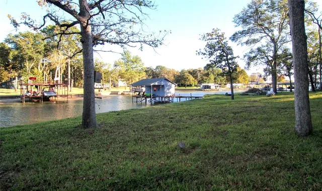 a backyard of a house with lots of green space and fountain