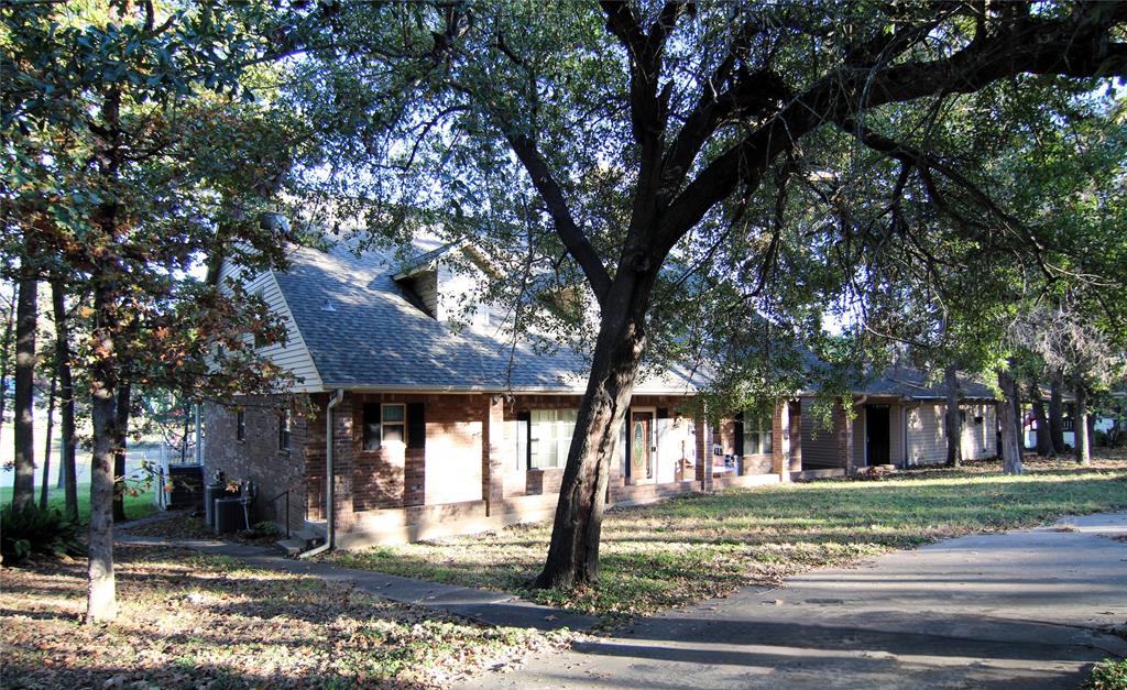 6928 Scott Street Eustace, TX 75124 - Photo 4 of 37 a view of a house with a tree next to a yard
