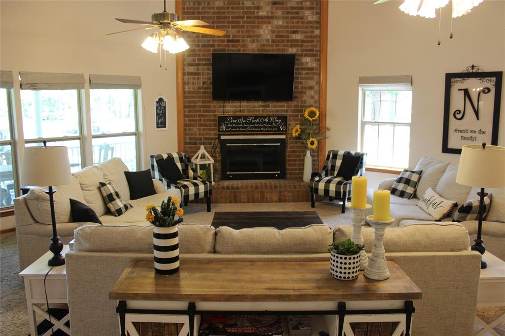 6928 Scott Street Eustace, TX 75124 - Photo 5 of 37 a living room with furniture a flat screen tv and a fireplace
