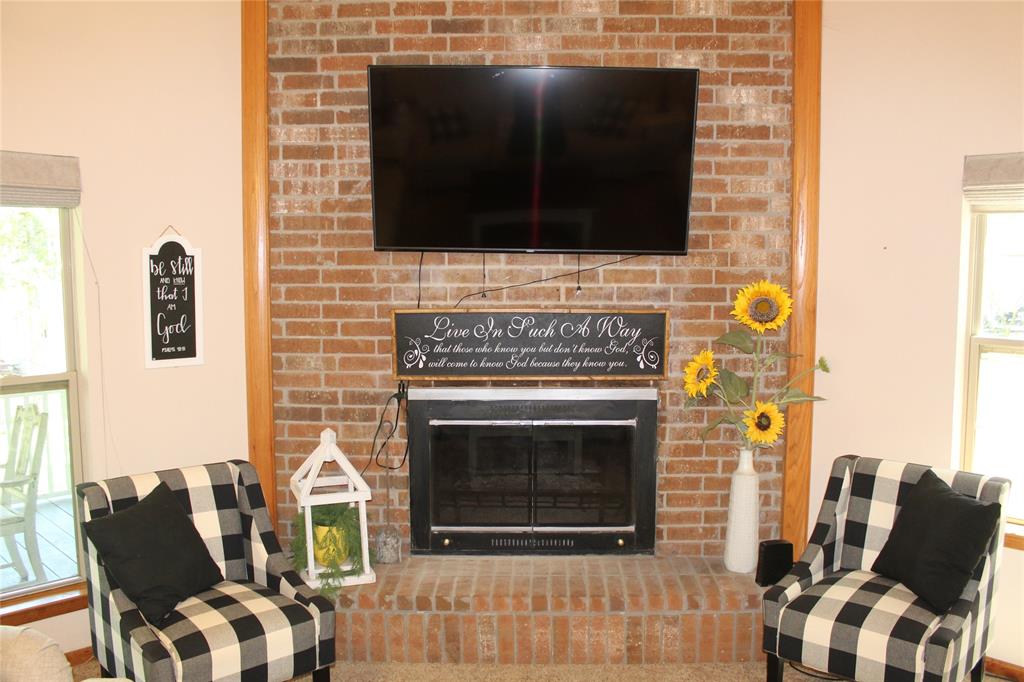 6928 Scott Street Eustace, TX 75124 - Photo 7 of 37 a living room with furniture a fireplace and a flat screen tv