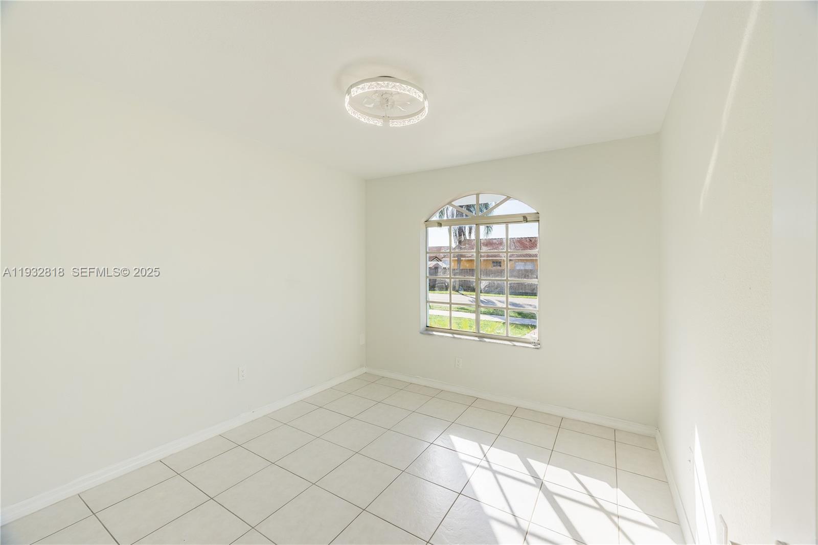 13797 Southwest 154th Street Miami, FL 33177 - Photo 12 of 14 a view of an empty room with a window