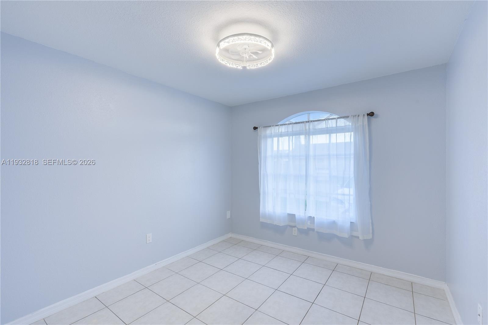 13797 Southwest 154th Street Miami, FL 33177 - Photo 12 of 22 a view of an empty room with a window