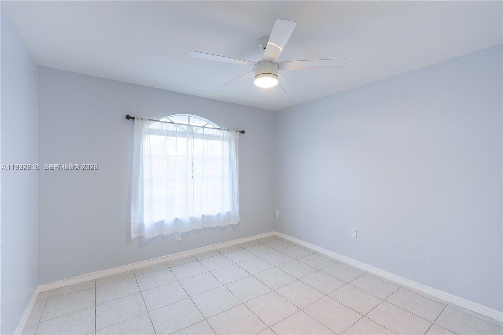 13797 Southwest 154th Street Miami, FL 33177 - Photo 15 of 22 wooden floor in an empty room with a window
