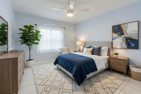a bedroom with a bed potted plant with the view of mirror