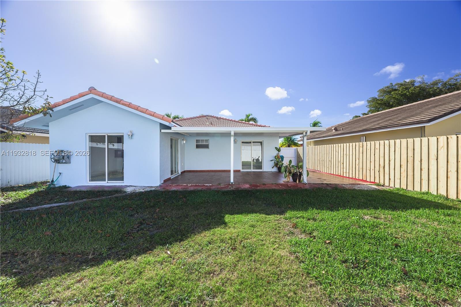 13797 Southwest 154th Street Miami, FL 33177 - Photo 2 of 22 a front view of a house with a yard and garage