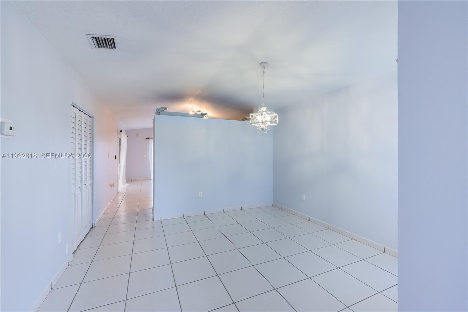 13797 Southwest 154th Street Miami, FL 33177 - Photo 5 of 22 a view of an empty room and a chandelier fan