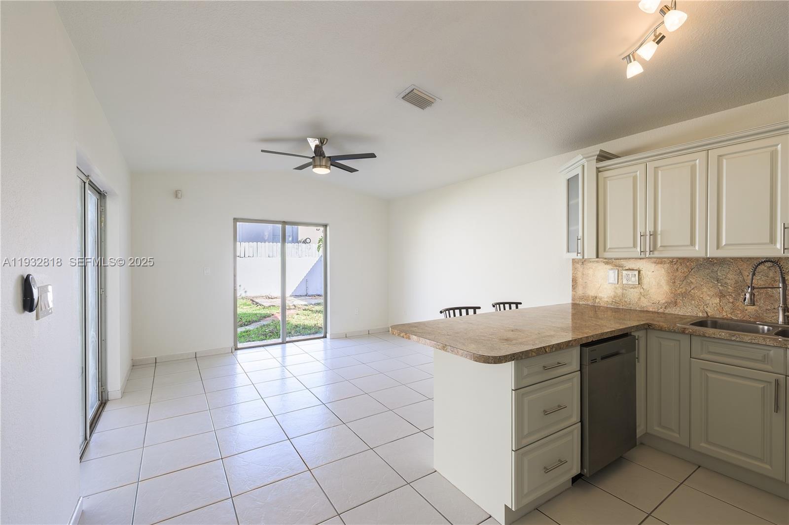 13797 Southwest 154th Street Miami, FL 33177 - Photo 6 of 14 a kitchen with a stove a sink and a refrigerator