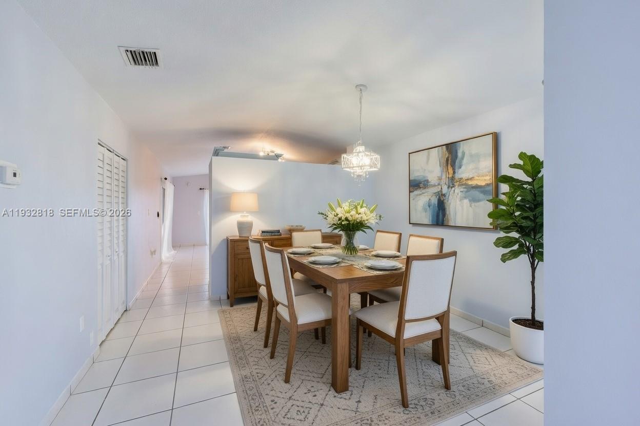 13797 Southwest 154th Street Miami, FL 33177 - Photo 6 of 22 a view of a dining room with furniture and wooden floor