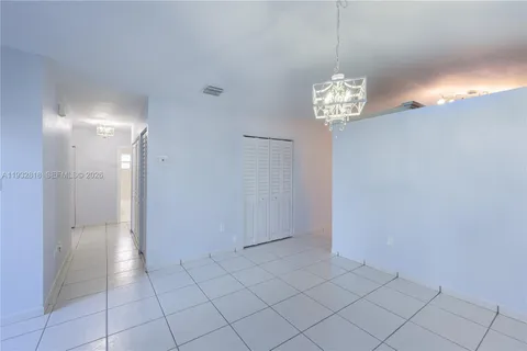 a view of a hallway with chandelier