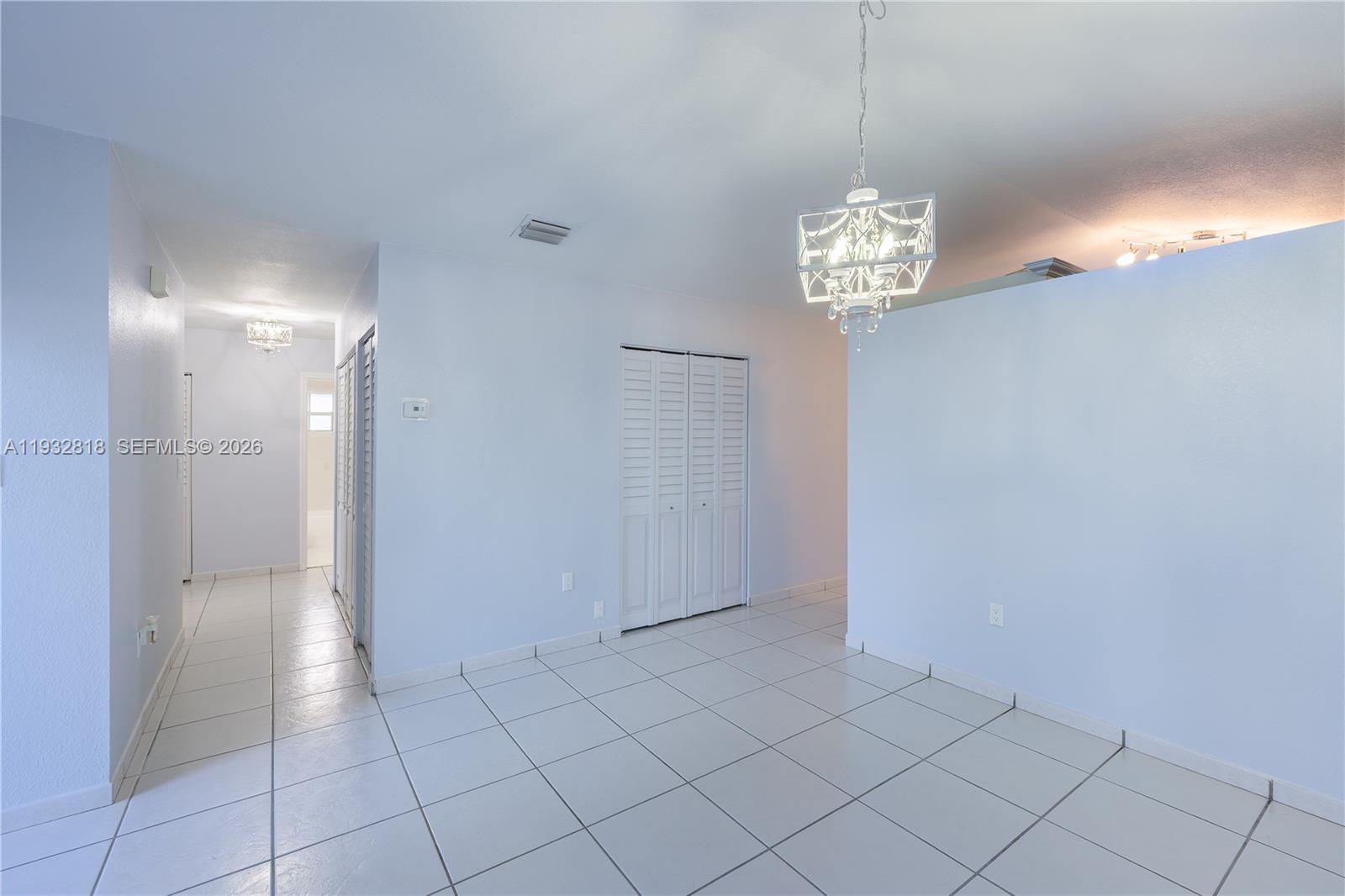 13797 Southwest 154th Street Miami, FL 33177 - Photo 7 of 22 a view of a hallway with chandelier