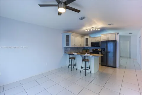 a kitchen with a cabinets and chairs