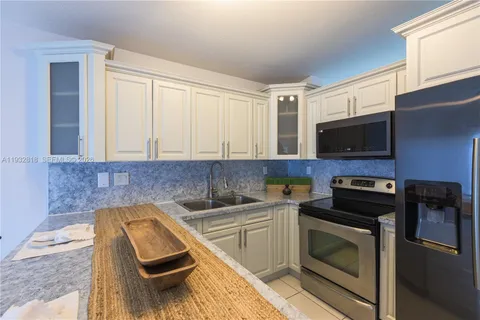 a kitchen with a sink and a stove top oven