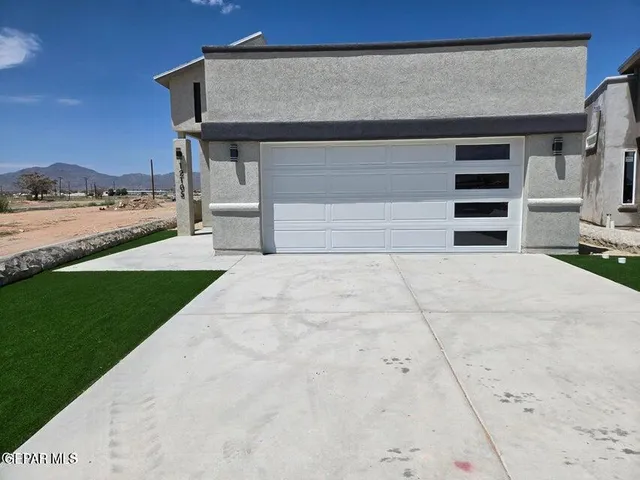 a view of a house with a sink and a yard in the back