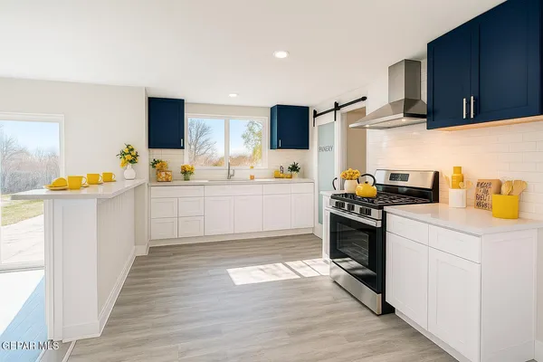 a kitchen with stainless steel appliances a refrigerator sink and microwave
