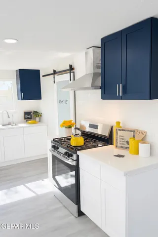 a big room with wooden floor a fireplace and a window