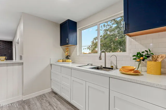 an empty room with wooden floor and mirror