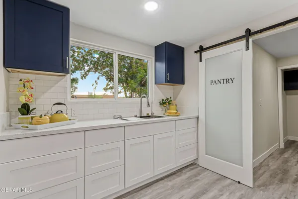 a bathroom with a granite countertop sink a mirror and shower