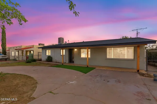 a view of a house with a backyard and balcony