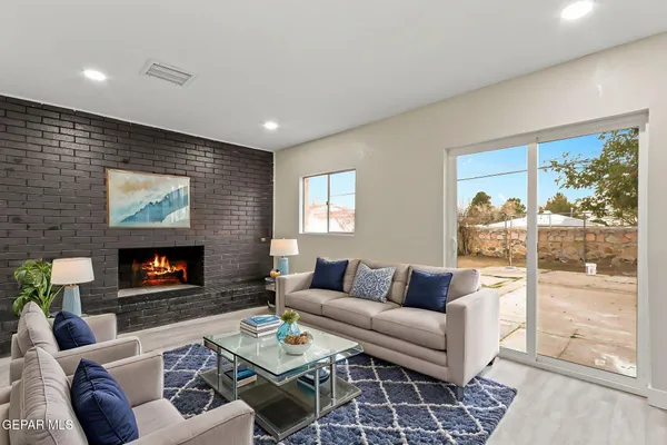 a bedroom with a large bed and a potted plant