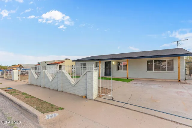 a front view of a house with a yard and a garage