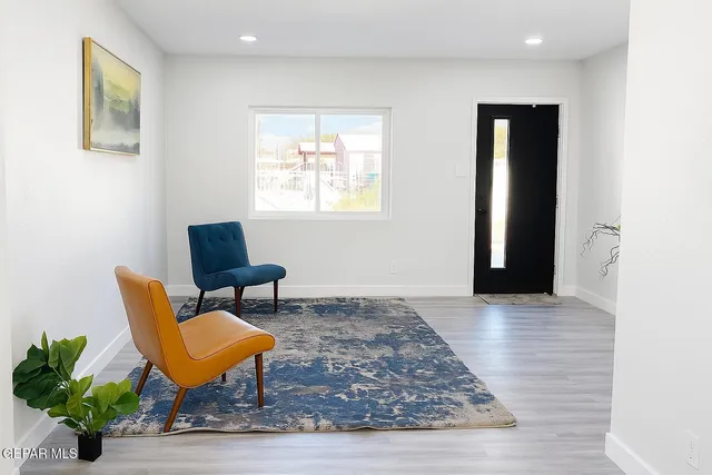 a living room with furniture and white walls